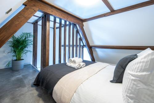 a bedroom with a bed and a large window at Family penthouse 7-Minutes from Rotterdam Central Newly Build top floor terrace R5 in Schiedam