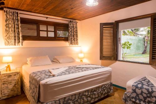 מיטה או מיטות בחדר ב-SURF HOUSE MORRO DO CHAPÉU "Pé na areia"