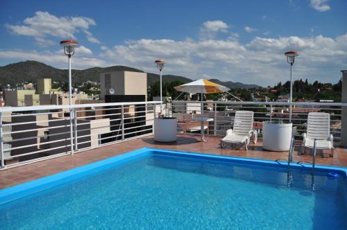 a swimming pool on the roof of a building at Hotel Arona in Villa Carlos Paz