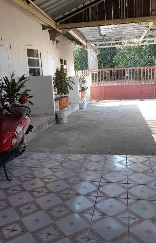 an empty parking lot in a building with plants at Pakchong hostel & wildlife tour in Pak Chong
