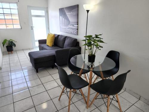 a living room with a table and chairs and a couch at San Juan Apartments in San Juan