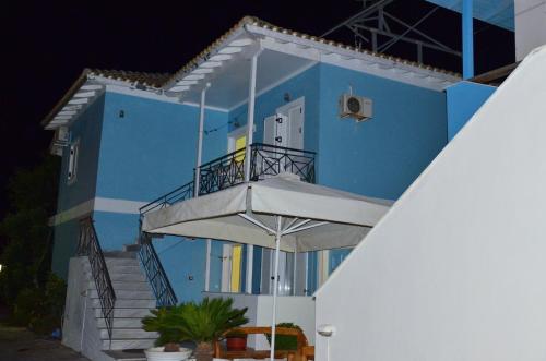 a blue building with stairs leading up to it at Pension Maria in Lefkada Town