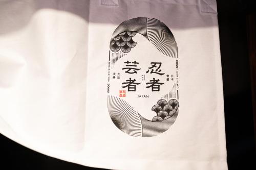 a black and white shirt with a picture of a hand at NINJA & GEISHA in Osaka