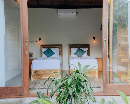Postel nebo postele na pokoji v ubytování Jati Kuta Lombok