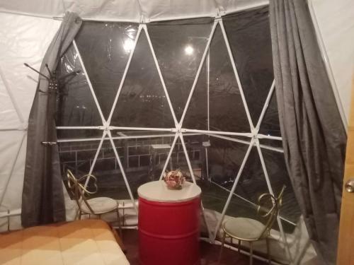 a room with a table and chairs in a tent at โดม มองโก แสงเพ็ญ in Khao Kho