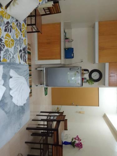 a kitchen with wooden cabinets and a counter top at Guest House in Cainta Rizal in Cainta