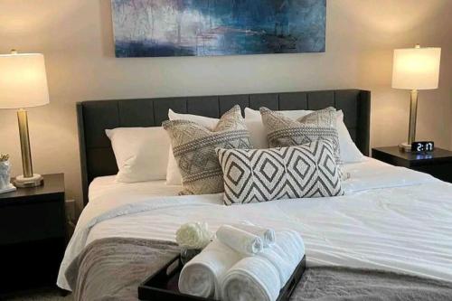 a bed with a tray of towels on it at Cozy 1bd in the heart of downtown Dallas!(w/parking) in Dallas