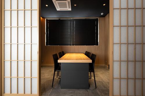 a conference room with a table and chairs at NINJA & GEISHA in Osaka