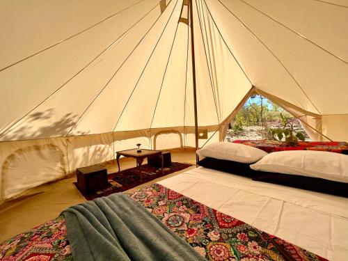 a tent with two beds and a table in it at Gorge View Bush Retreat : Katherine NT in Katherine