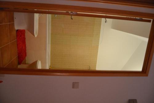 a mirror in a bathroom with a toilet and a sink at Retiro da Lameira in Seia