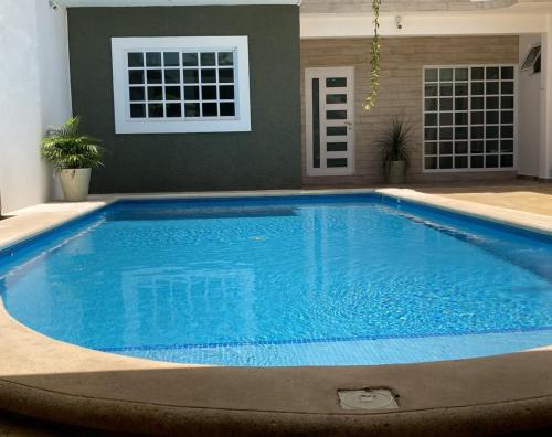 a large blue swimming pool in a house at HomeCancun2 in Cancún