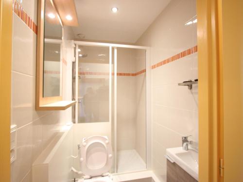 a bathroom with a shower and a toilet and a sink at Studio Chamrousse, 1 pièce, 3 personnes - FR-1-549-95 in Chamrousse