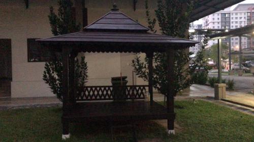 a small gazebo sitting on the grass at Roomstay in Putrajaya (Female only/Queen bed) in Kampong Batu Sembilan
