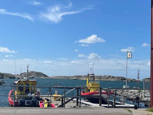 a boat is docked at a dock in the water at 4 person holiday home in Skärhamn-By Traum in Skärhamn