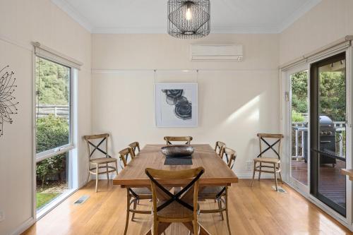 a dining room with a wooden table and chairs at Yarra Gables in Healesville