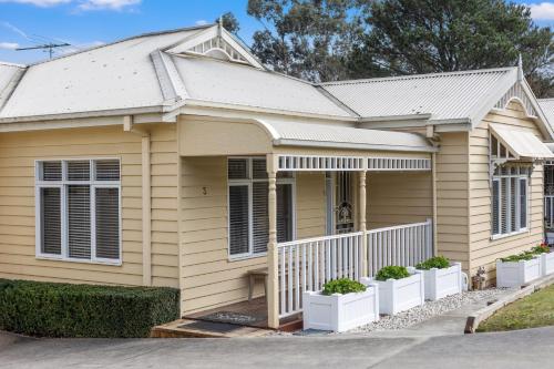 a yellow house with plants in front of it at Yarra Gables in Healesville