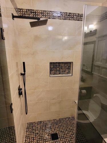 a bathroom with a shower with a glass door at Newly Renovated Private Ranch Get-A-Way in Pilot Point