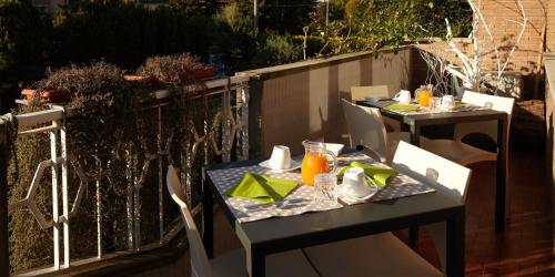 two tables on a balcony with food on them at La Dimora Del Bassotto in San Giuliano Terme