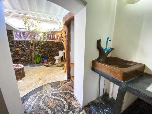 a bathroom with a sink in a room at Sayang Mama Inn in Gili Air