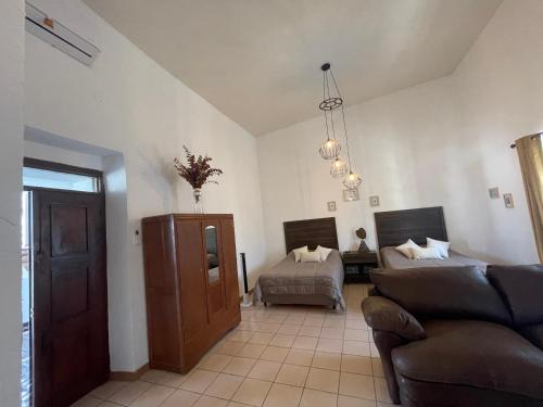a living room with a couch and a bed at Casa Praxedis in Santiago
