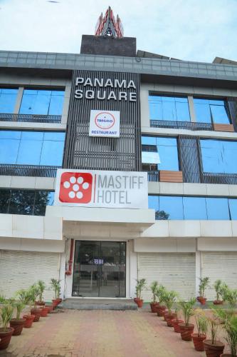 a building with a sign on the front of it at Mastiff Hotel Ankleshwar in Ankleshwar