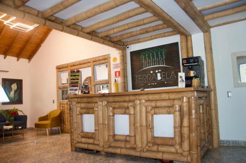 a large wooden bar in a room with a ceiling at Eco Hotel Terrabella in Santa Elena