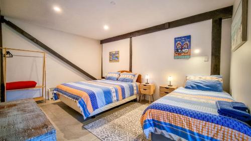 a bedroom with two beds in a room at Carters Beach Seaside Accommodation in Carters Beach