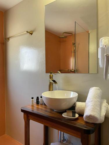 a bathroom with a white sink and a mirror at Midgard Suites (Medieval Town) in Rhodes Town
