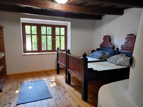 a bedroom with two beds and a window at Fülei Vendégház in Füle