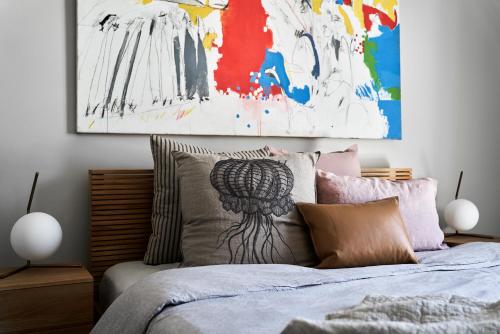 a bedroom with a bed with a painting on the wall at Hotel Ernest Bendigo in Bendigo