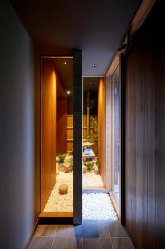 a hallway with a door leading to a yard at 古今 天下茶屋 with a private parking lot and a half open-air bath and direct to KIX in Osaka