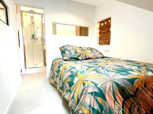 - une chambre avec un lit et une couverture colorée dans l'établissement Baby Loft Centre Historique, à Toulouse