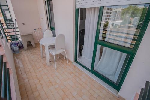 a room with a table and chairs and a window at Charming Private Rooms in an Apartment A1 Penha - Faro in Faro