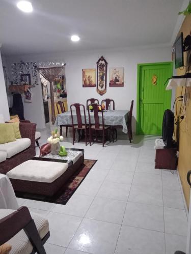 a living room with a couch and a green door at Posada Green Sea San Luis pesos with breakfast included starting in March in Cueva de Morgan