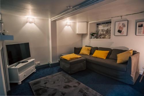 a living room with a couch and a television at Entire character property in heart of Norwich in Norwich