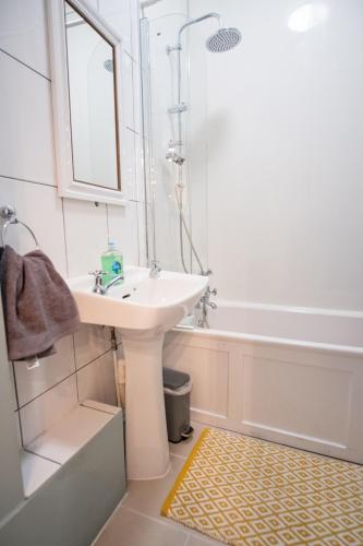 a white bathroom with a sink and a tub at Entire character property in heart of Norwich in Norwich