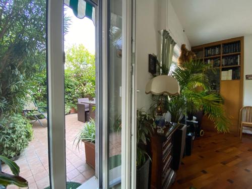 um quarto com uma porta de vidro deslizante com plantas em Terrazza Milano Apartment em Milão