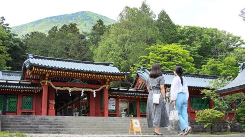 two women standing on steps in front of a building at Yutorelo Nikko in Nikko