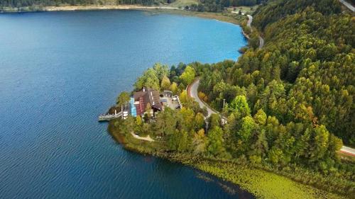 an island in the water with a house on it at Abant Kosk Oteli in Abant