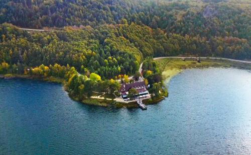 a house on an island in the middle of a lake at Abant Kosk Oteli in Abant