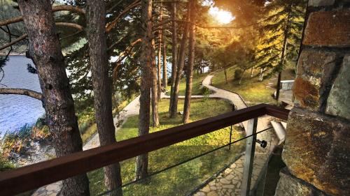 a balcony with a view of a river and trees at Abant Kosk Oteli in Abant