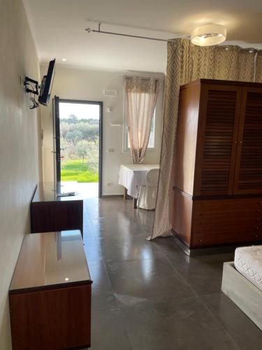 a large living room with a bed and a table at Residenze La Villa in Foggia
