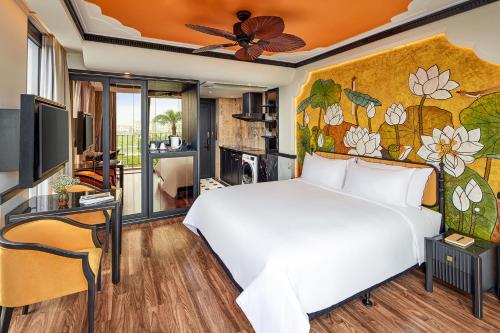 a bedroom with a white bed and a wall with flowers at Ravatel Style Hotel Bac Giang in Bắc Giang