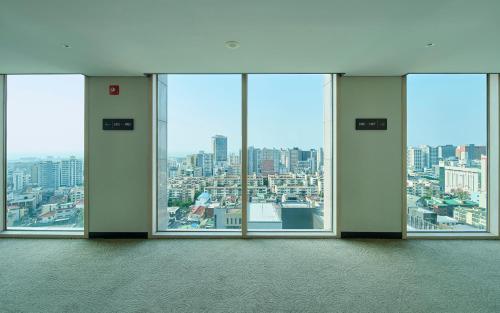 an empty room with a view of a city at Jeju Central City Hotel in Jeju