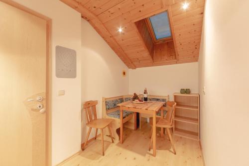 a dining room with a wooden table and chairs at Residence Alpina in Santa Maddalena in Casies