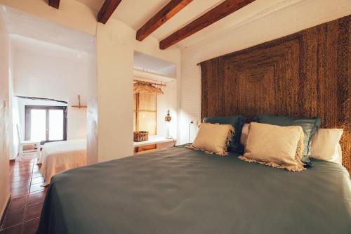 a bedroom with a large bed with two pillows at Casa Ilusión Altea in Altea
