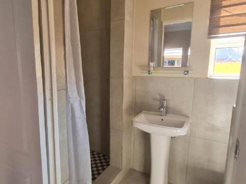 a bathroom with a sink and a mirror at Benoni N12 Hotel in Benoni