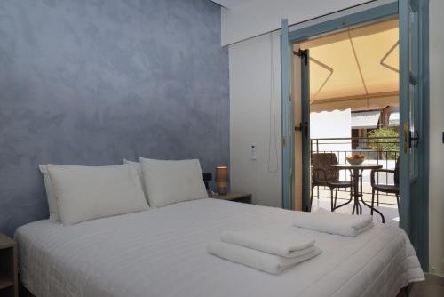 a bedroom with a white bed with towels on it at Amara Porto Living in Chania Town