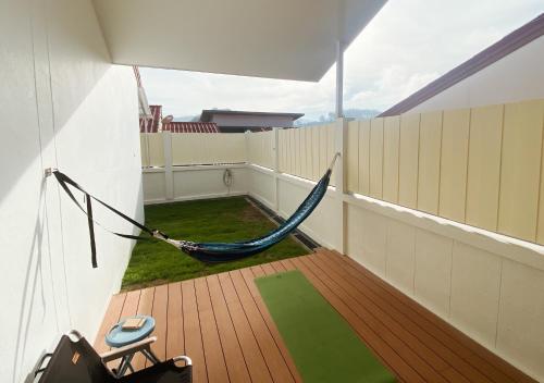 a hammock on the balcony of a house at Sundae Haus in Betong