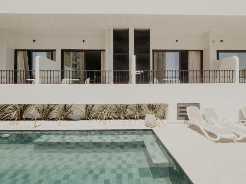 a villa with a swimming pool and a house at Comfy Studios in Benalmádena